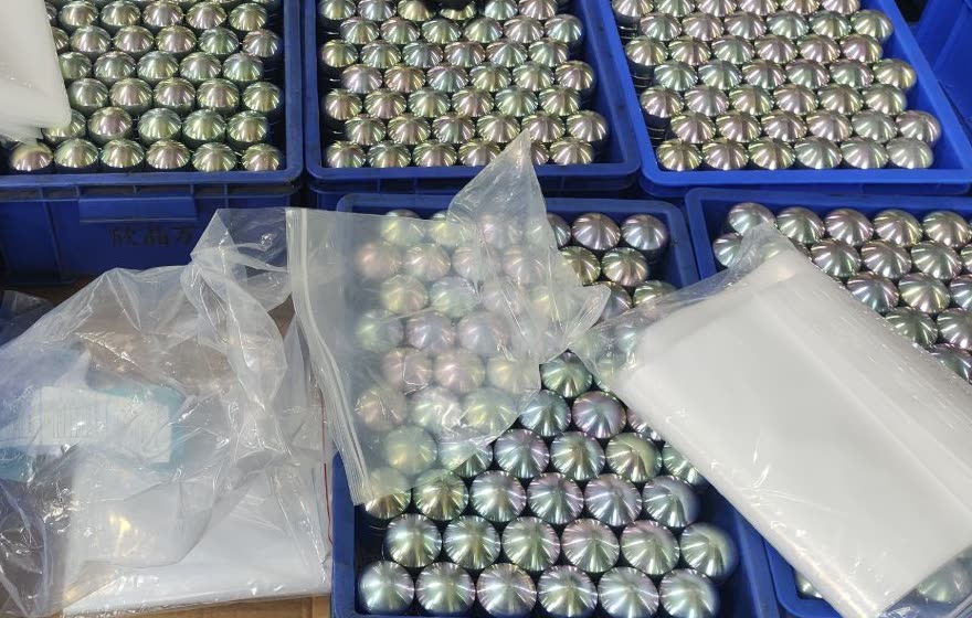 Batch of color zinc-plated dome-shaped parts in packing trays