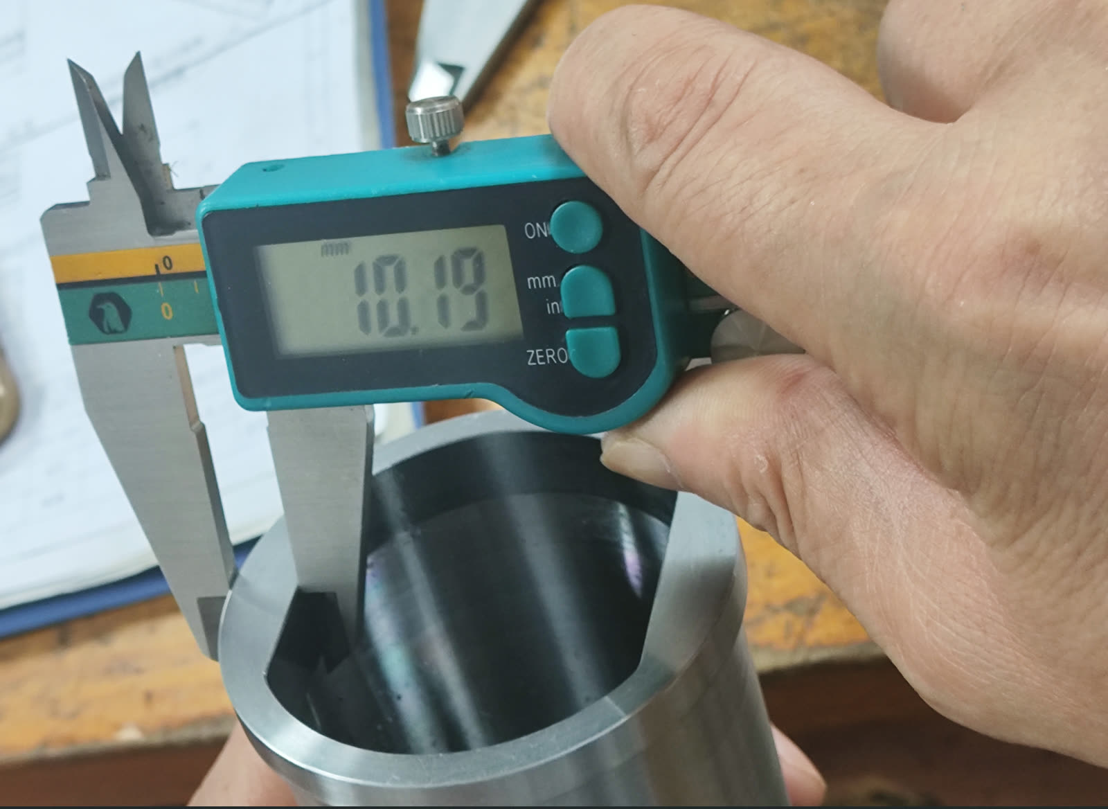 Digital caliper measuring a bore on the bench