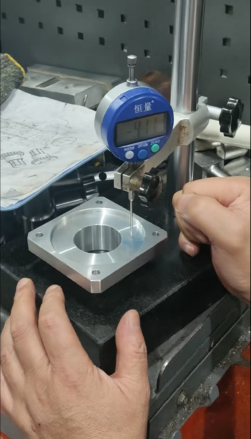 Height gauge checking a flange on a granite surface plate